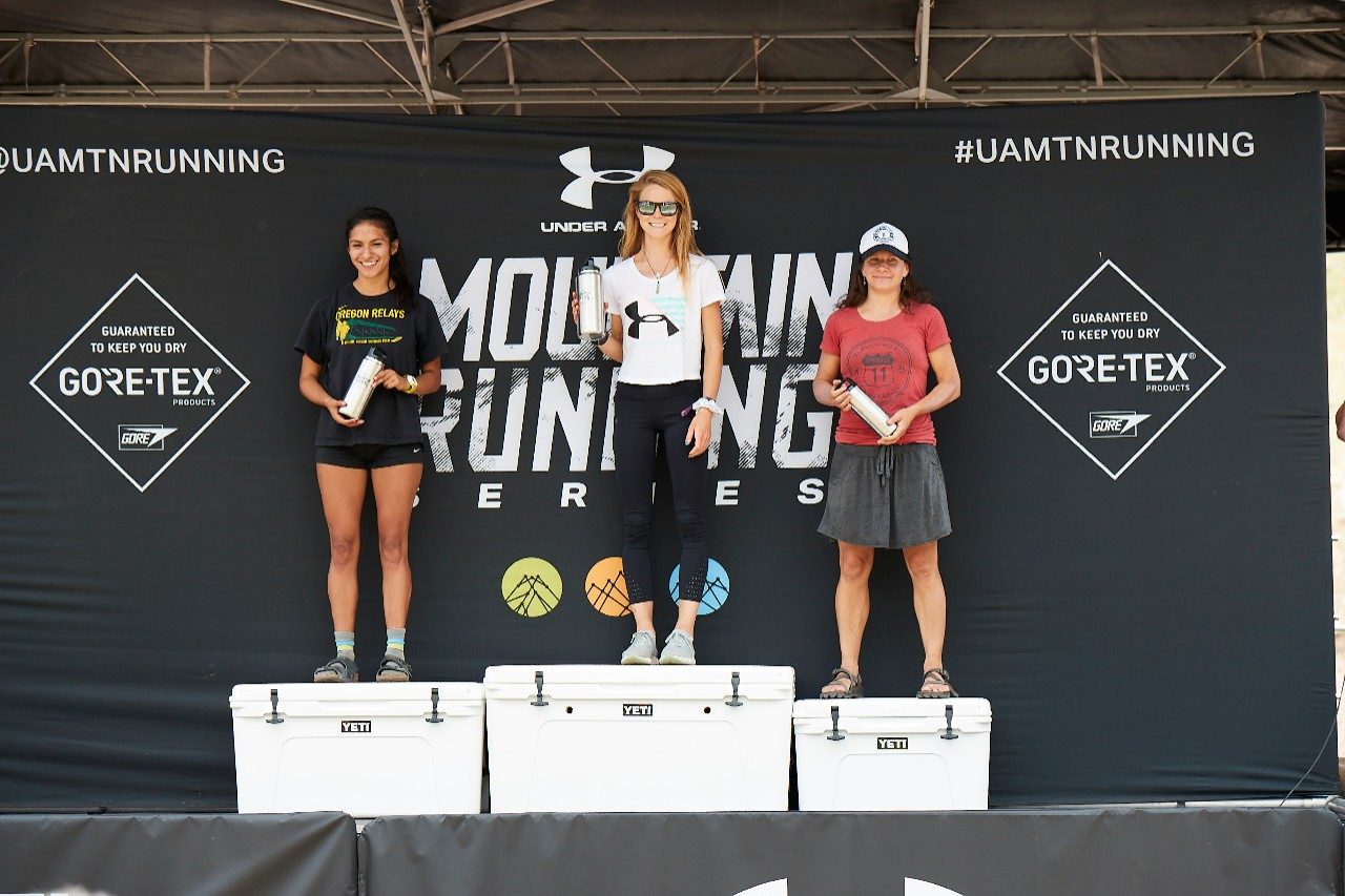 UA athlete Kelly Wolf takes the top position on the podium at the award ceremony following her 25K victory