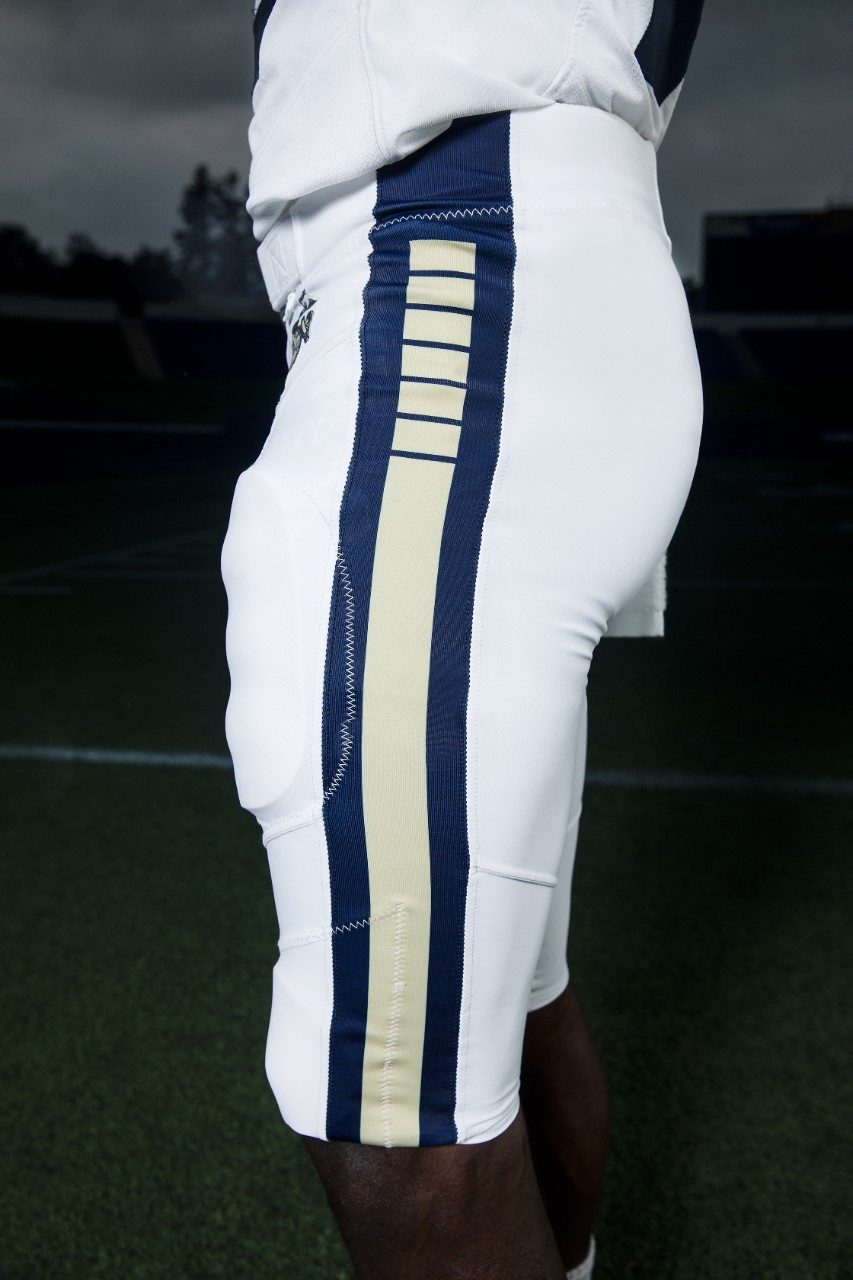 To match the jersey, the pants were designed in the same shade of navy blue with a stripe down the panel featuring six breaks. This same design is echoed on the helmet, since the United States Navy was founded by Congress with six frigates.

The one consistent element that this uniform shares with Navy’s current standard uniforms is the Eagle, Globe and Anchor, the official emblem and insignia of the United States Marine Corps, which is seen on the pant hip.