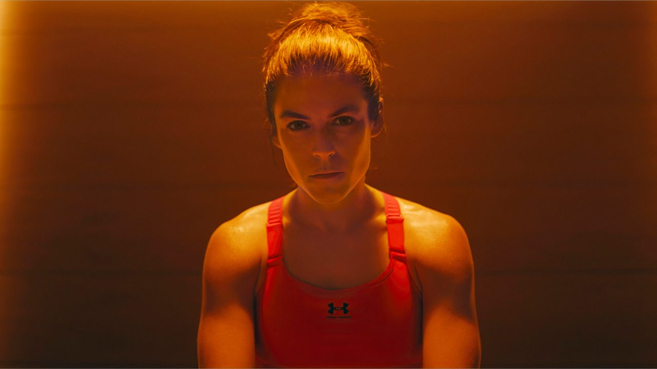 Tight shot of Kelley O'Hara looking at the camera wearing the Under Armour Meridian Sports Bra
