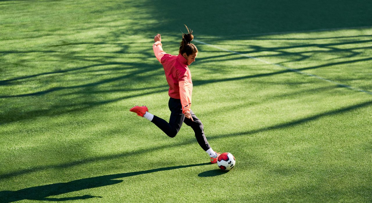 Kelley O'Hara kicking a ball
