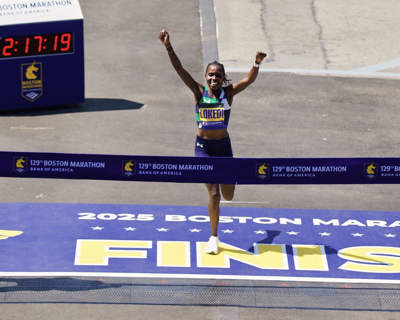 Sharon Lokedi crossing Finish Line winning Boston Marathon in UA Velociti 3