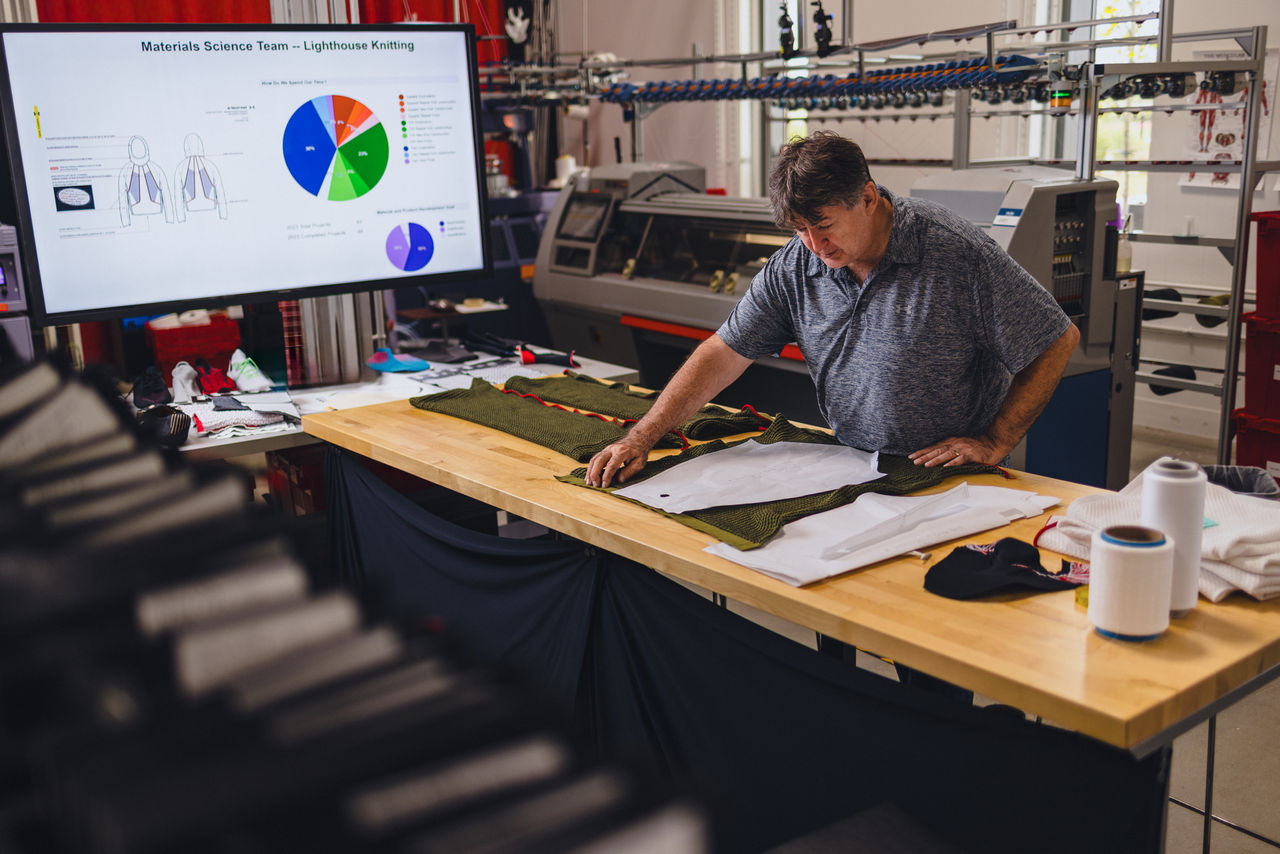 Worker measures clothing pattern