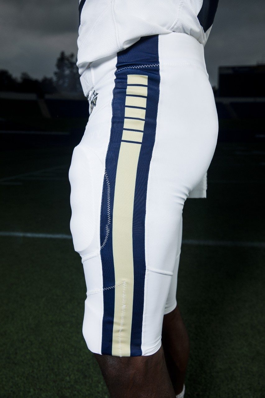 To match the jersey, the pants were designed in the same shade of navy blue with a stripe down the panel featuring six breaks. This same design is echoed on the helmet, since the United States Navy was founded by Congress with six frigates.

The one consistent element that this uniform shares with Navy’s current standard uniforms is the Eagle, Globe and Anchor, the official emblem and insignia of the United States Marine Corps, which is seen on the pant hip.