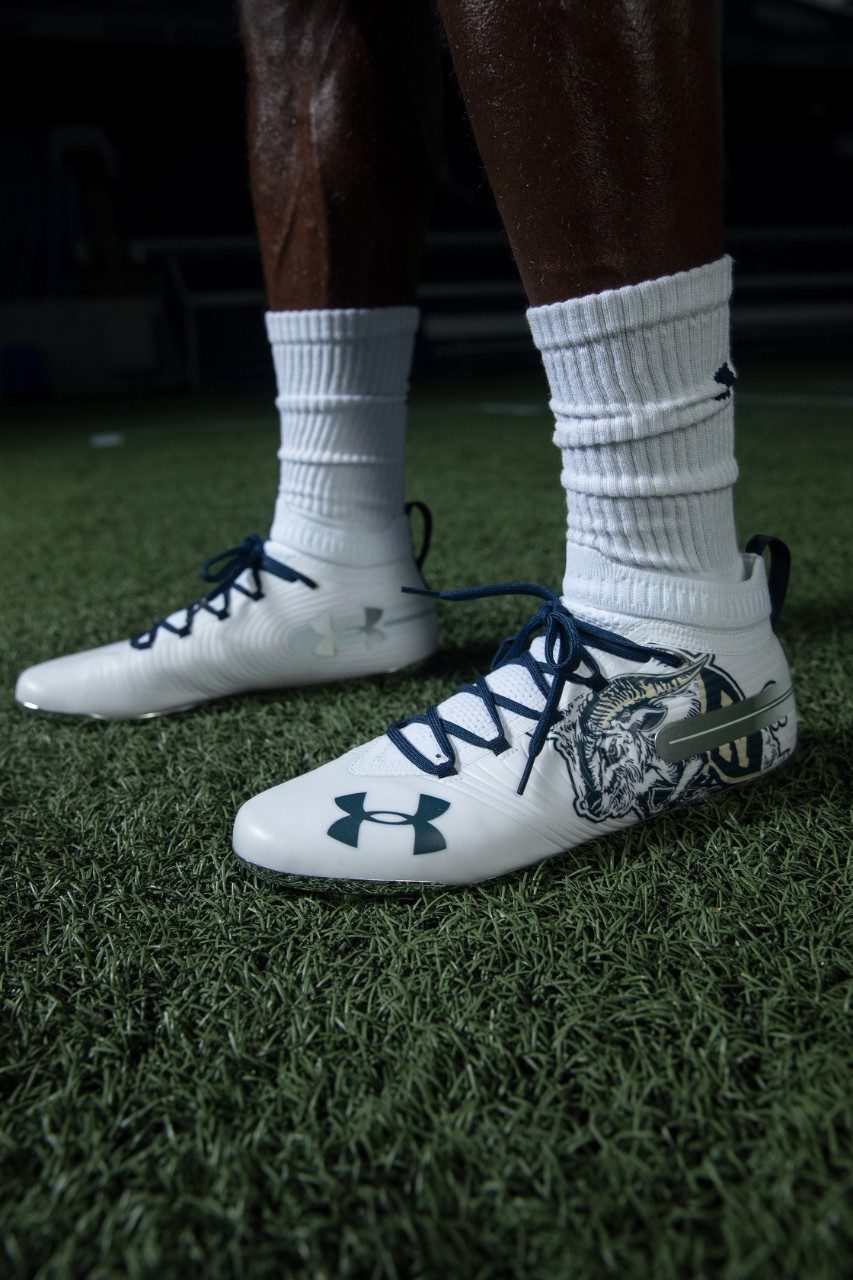 Bill the Goat also decorates the midshipmen's gloves and cleats.