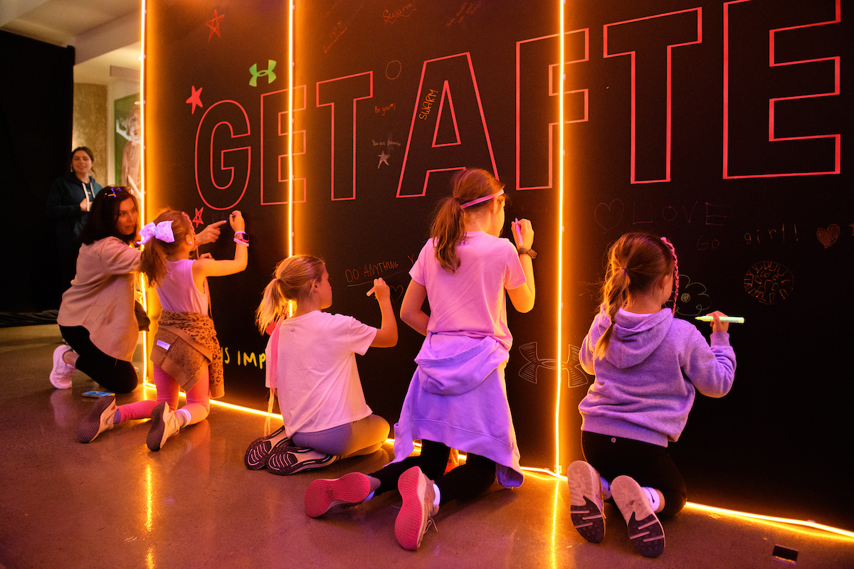 Young Female Athletes writing on Hype Headqaurters wall