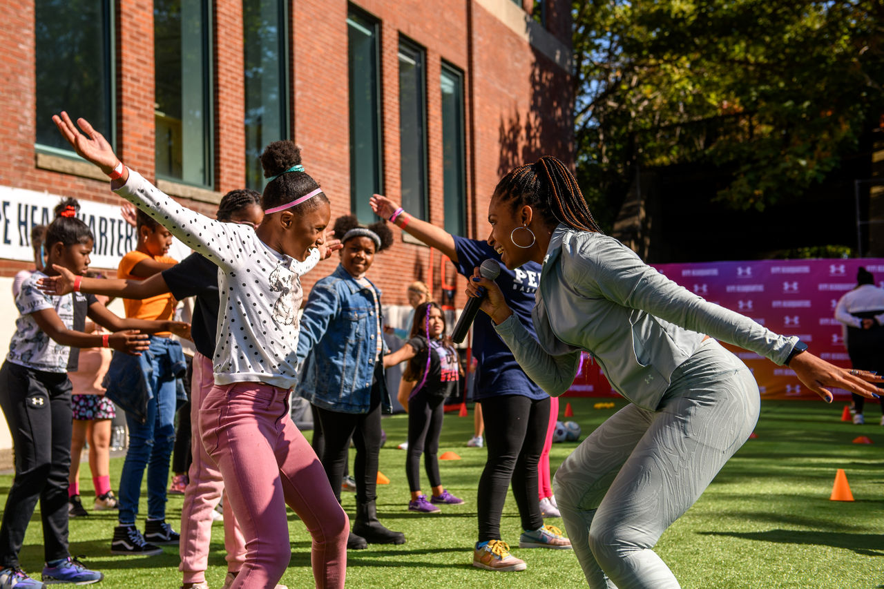 Ariel Belgrave, health and fitness coach hyping up young female athletes
