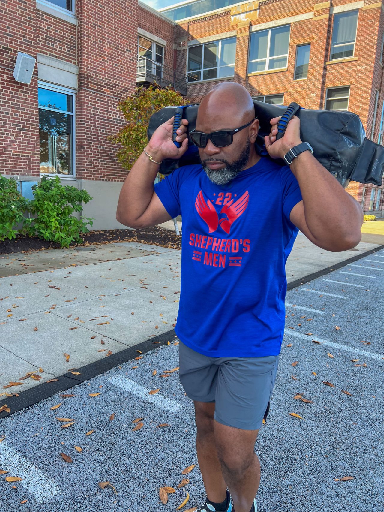 Man at UA HQ On Field Carrying Sand Bag