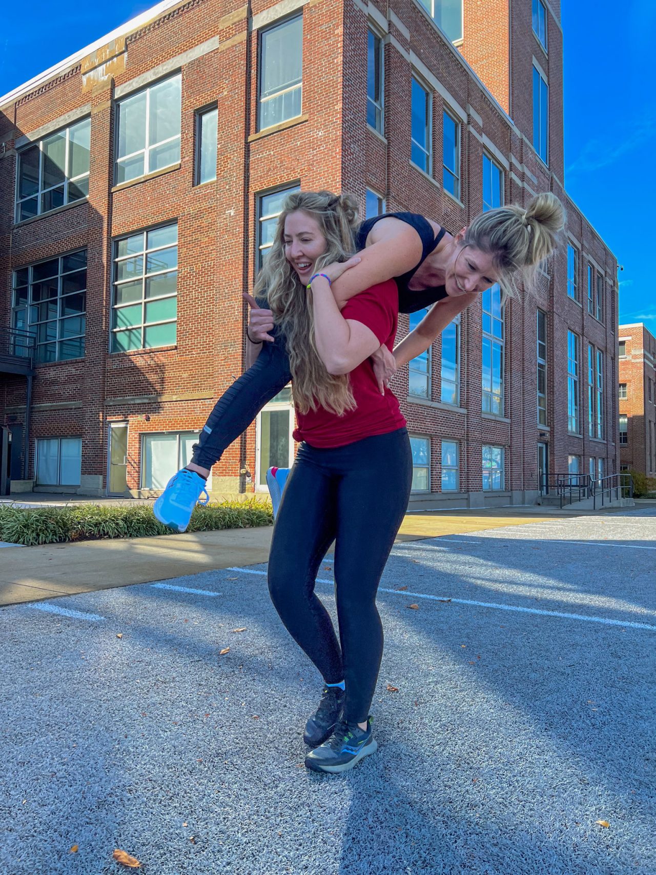 Women on field at UAHQ doing over shoulder carries